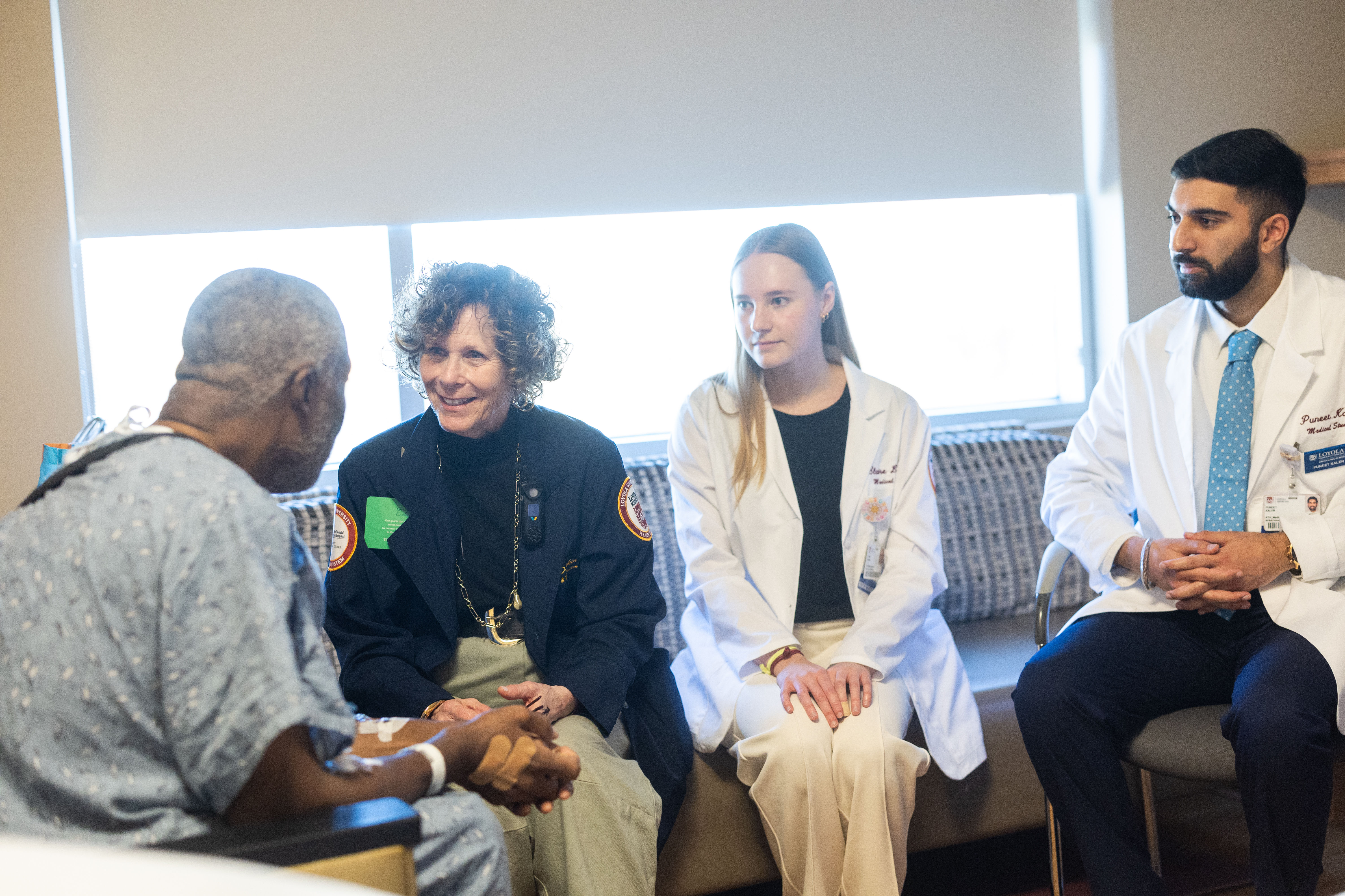 Loyola Stritch students accompany an LUHS Chaplain to visit with a patient.