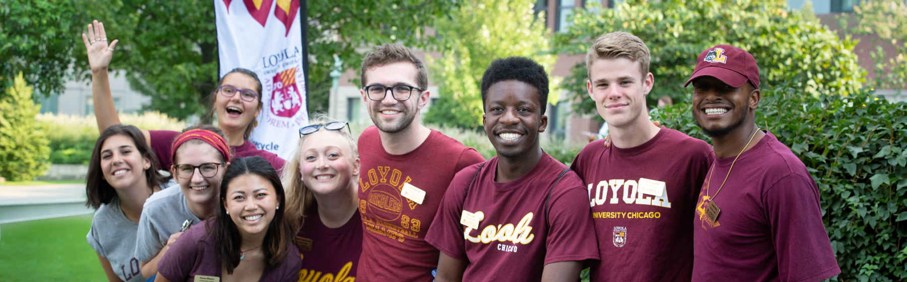 A group of Loyola students wearing merch and smiling.