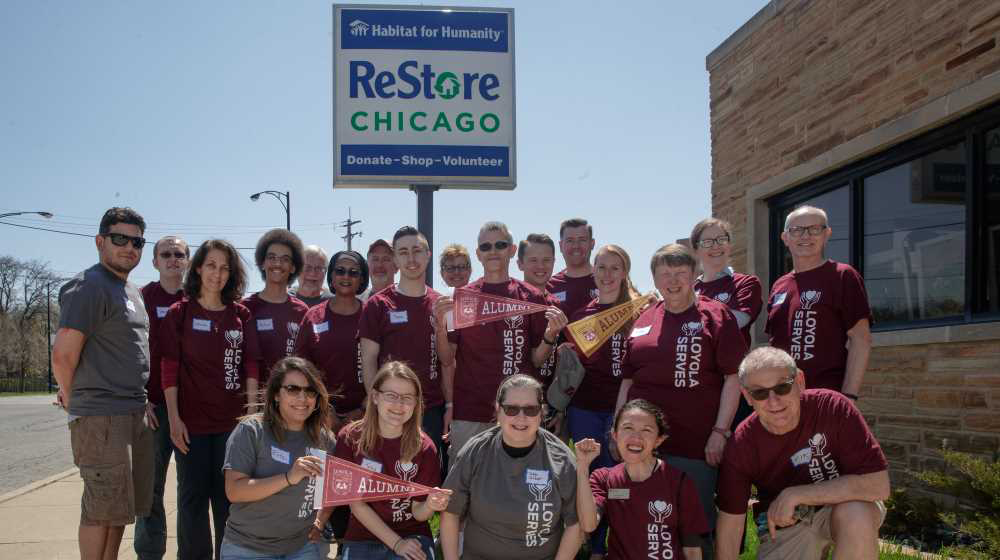 Alumni in maroon Loyola Serves tee shirts volunteer at Restore Chicago.