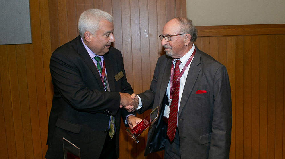 Dean Sam J Marzo presents the 2025 Excellence in Service to Patients to James V. Talano, MD 65, BS 61.