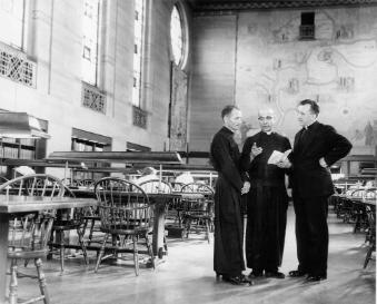 Three Jesuits in the Cudahy Library reading room.