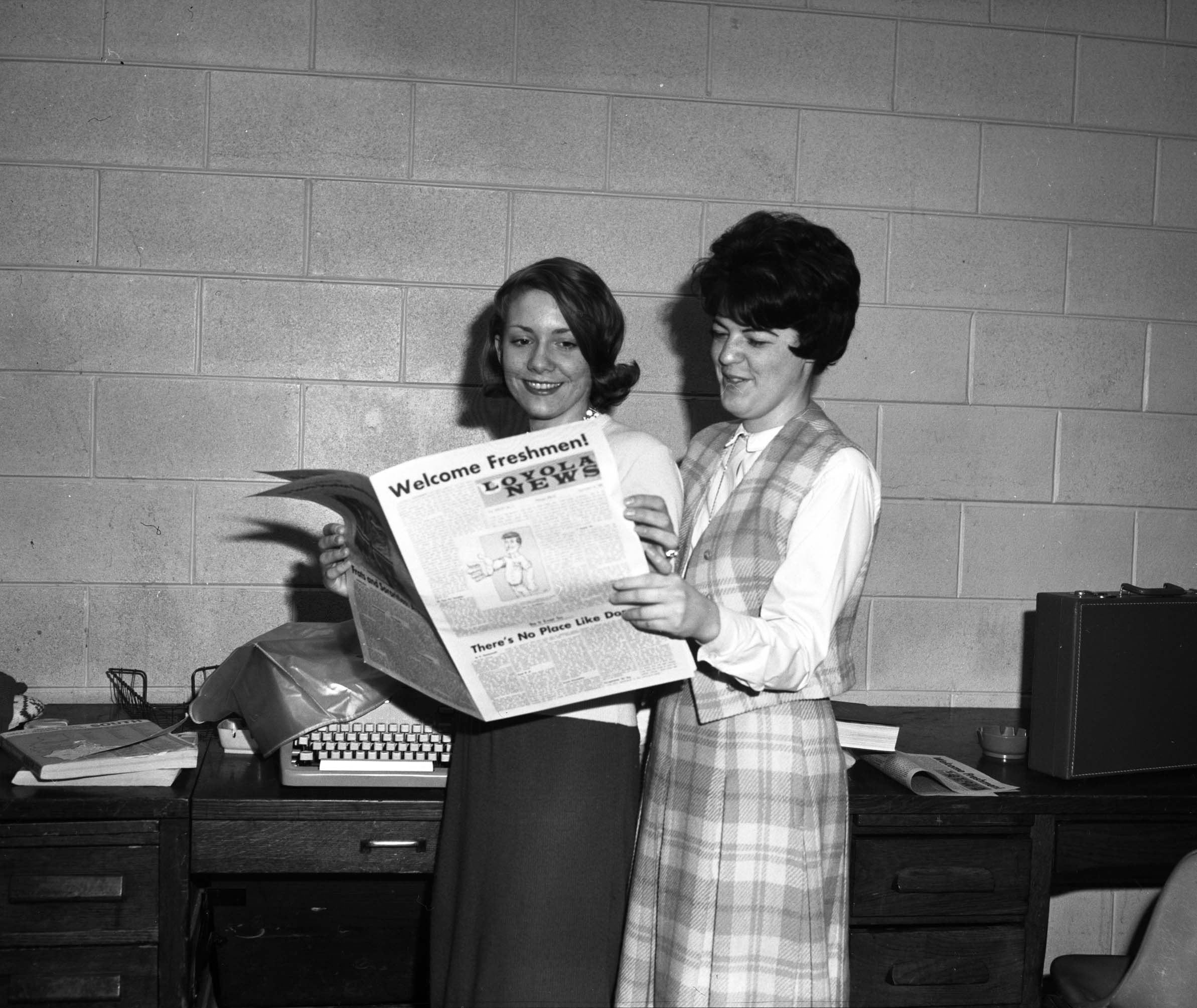 Loyola News staffers with paper