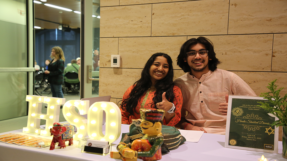Two students smiling next to the letters HSO