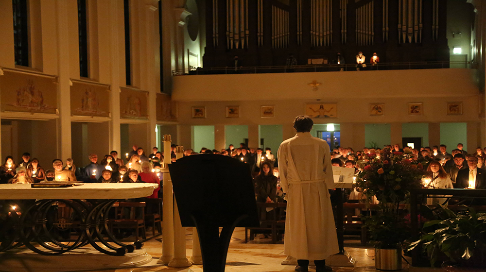The back of a Priest facing towards the congregation