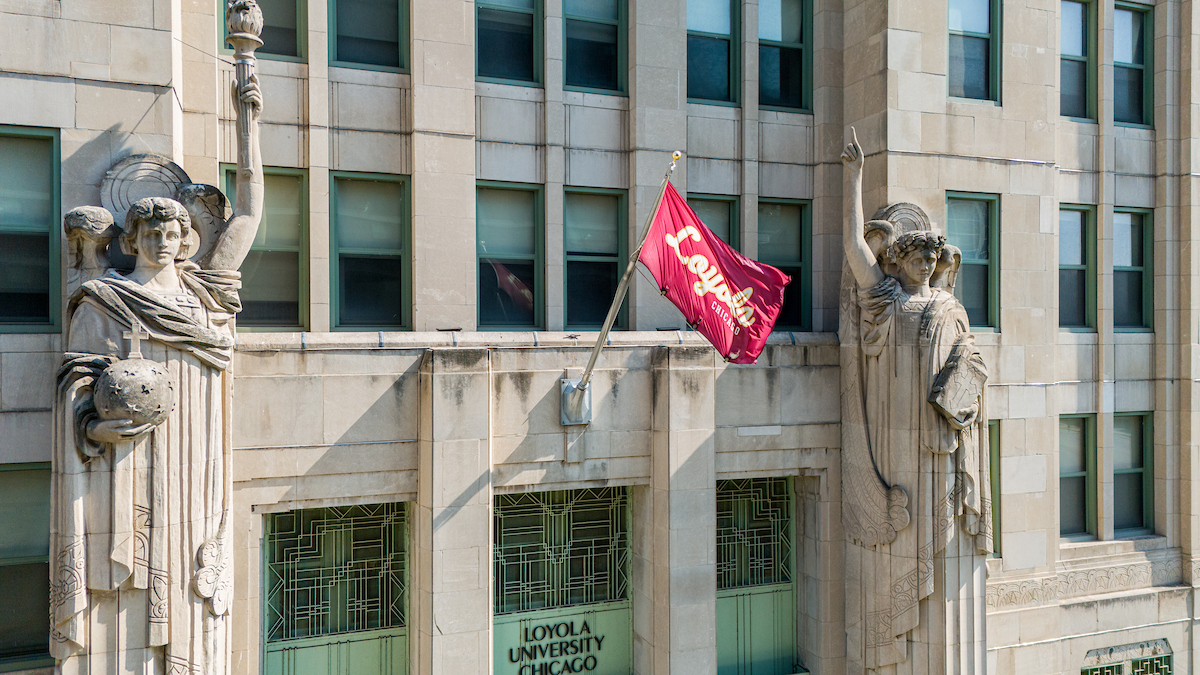 Loyola Flag on Campus Building