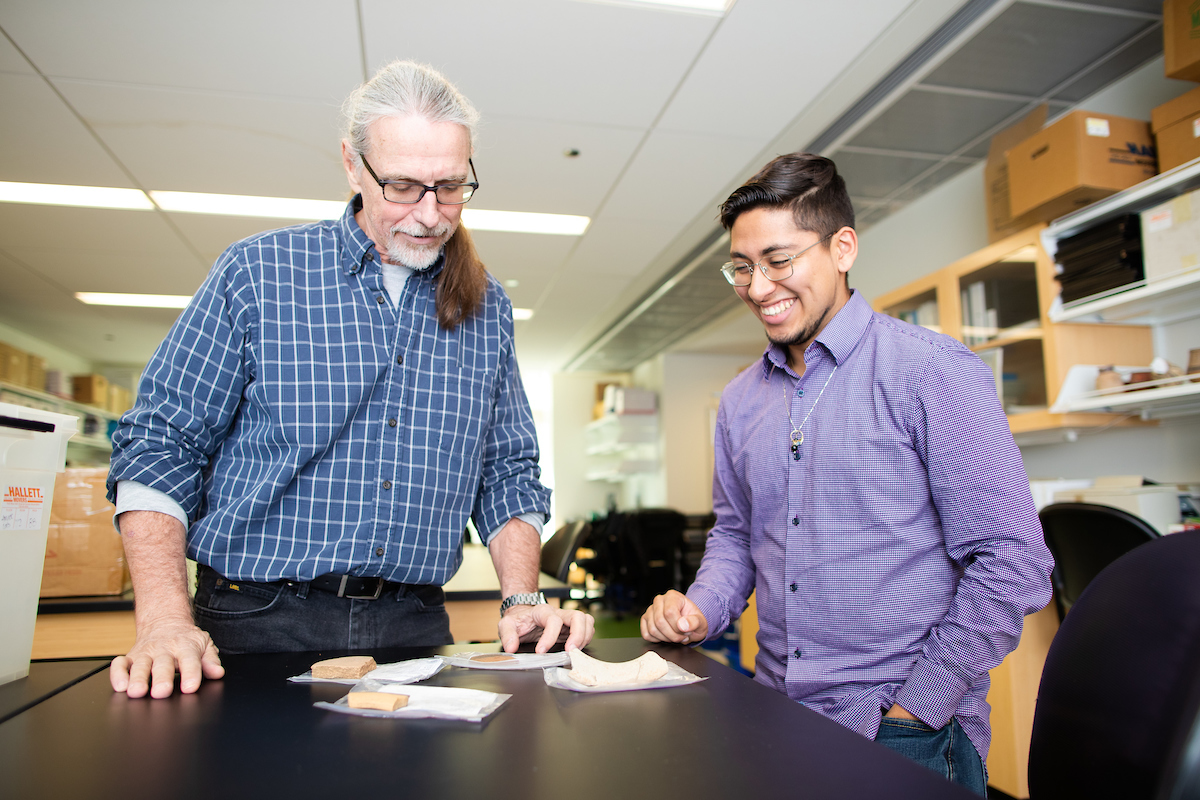 Anthropology major Nicholas Puente in the lab with his mentor Phillip Arnold, III, PhD, Professor of Anthropology.