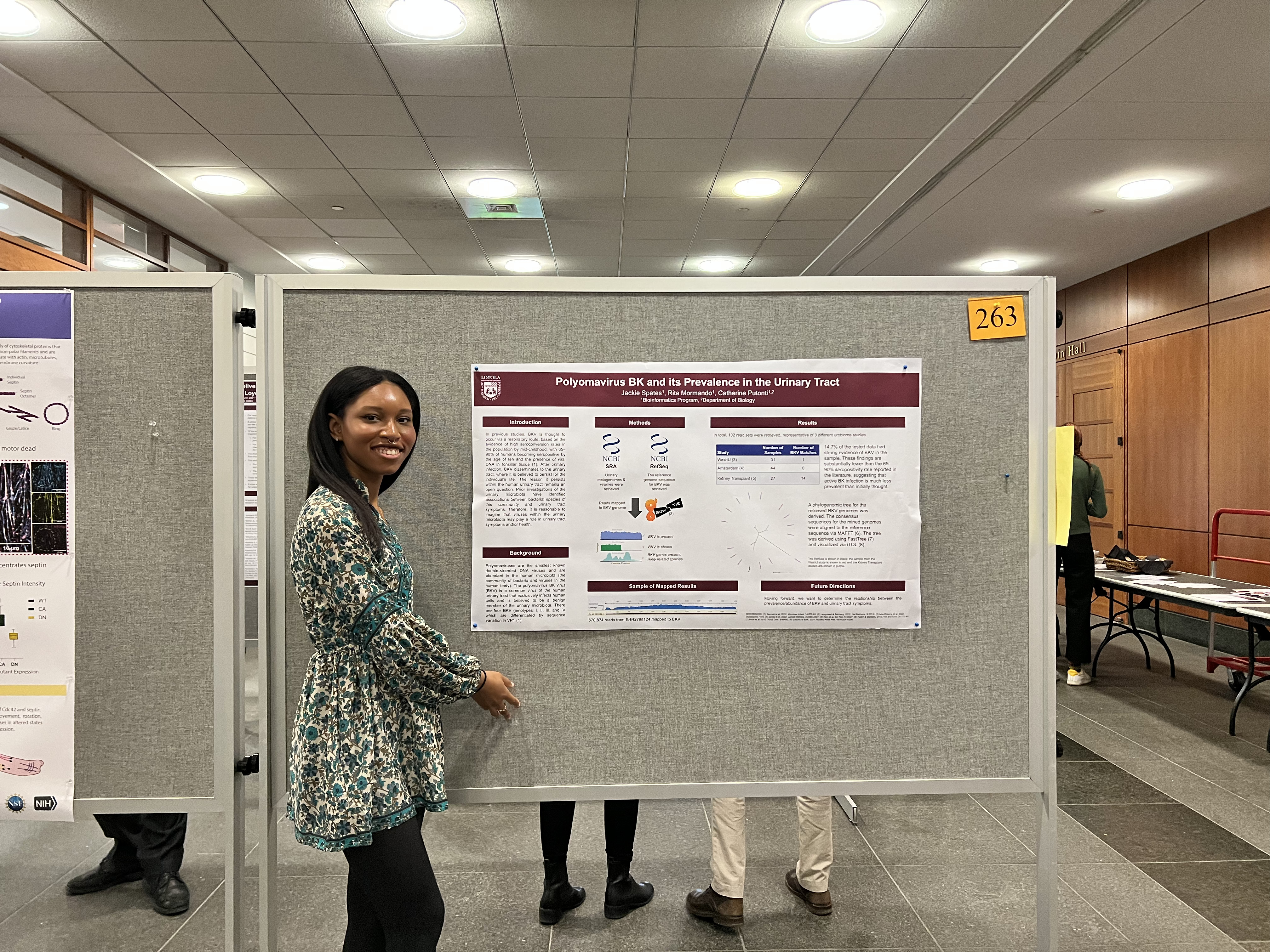 Student standing in front of a presentation poster