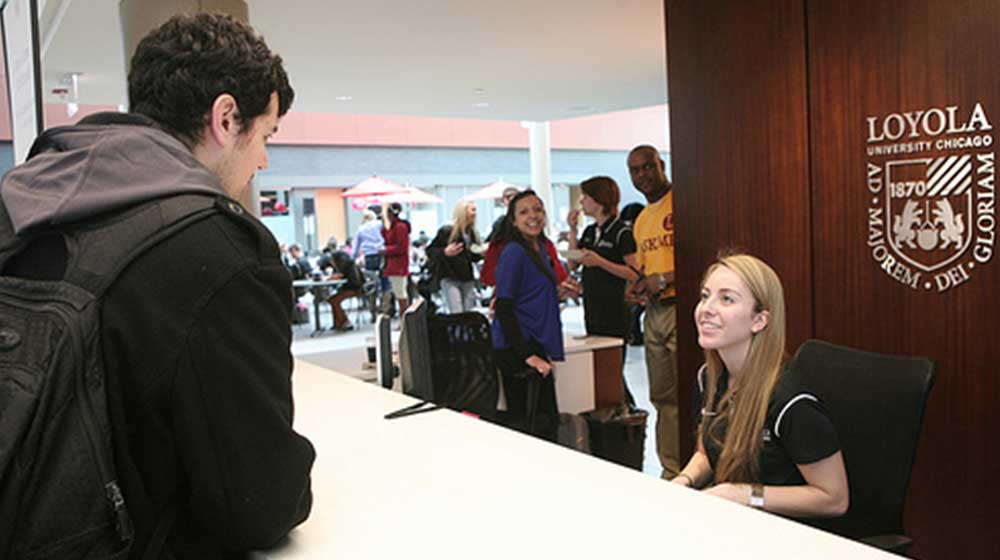 Student workers offer assistance at Damen Student Center info desk