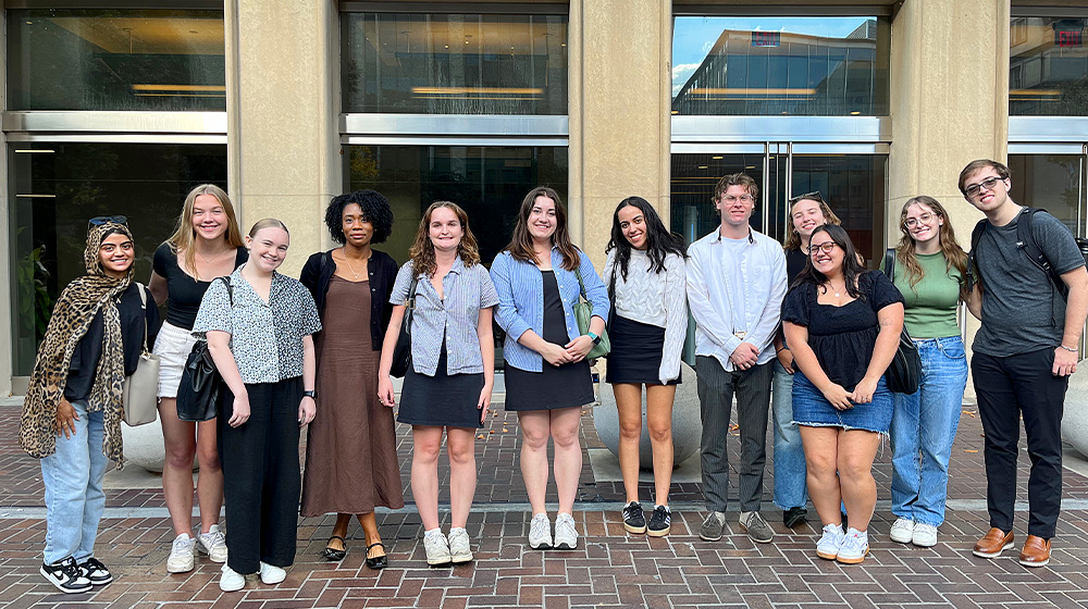 Eight Loyola students standing outside