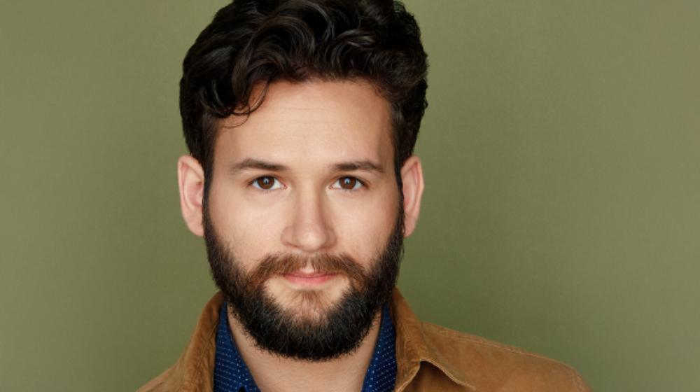 John Drea in a portrait studio, standing in front of a backdrop.
