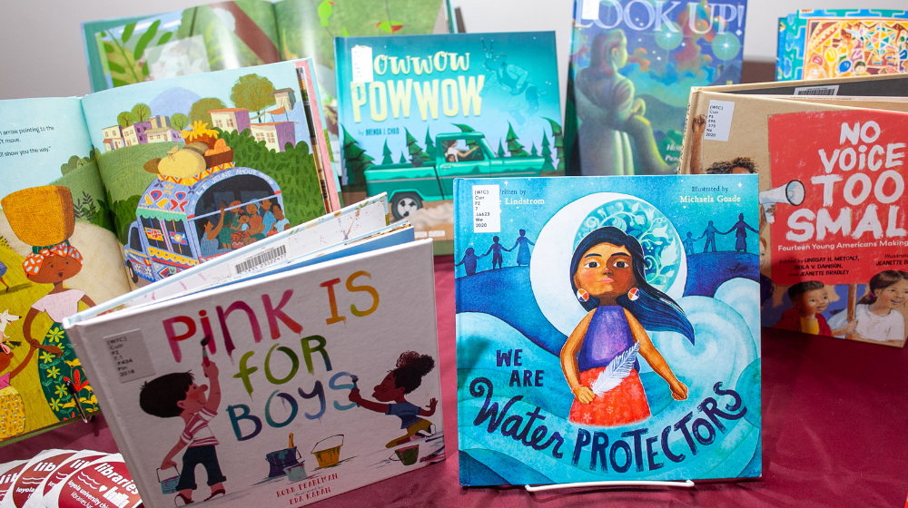 A table showcases a variety of inclusive children's books.