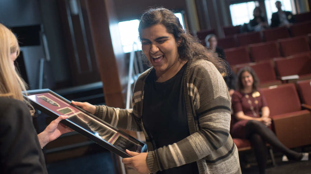 A student proudly accepts their award.