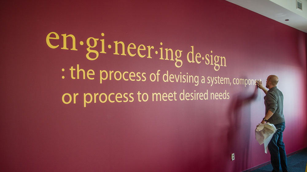 Lettering being added before the First Year Design Classroom (Cuneo 303) opened.