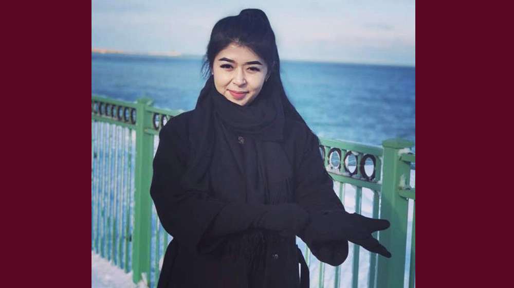 Aigerim outside near the lakeshore in the winter