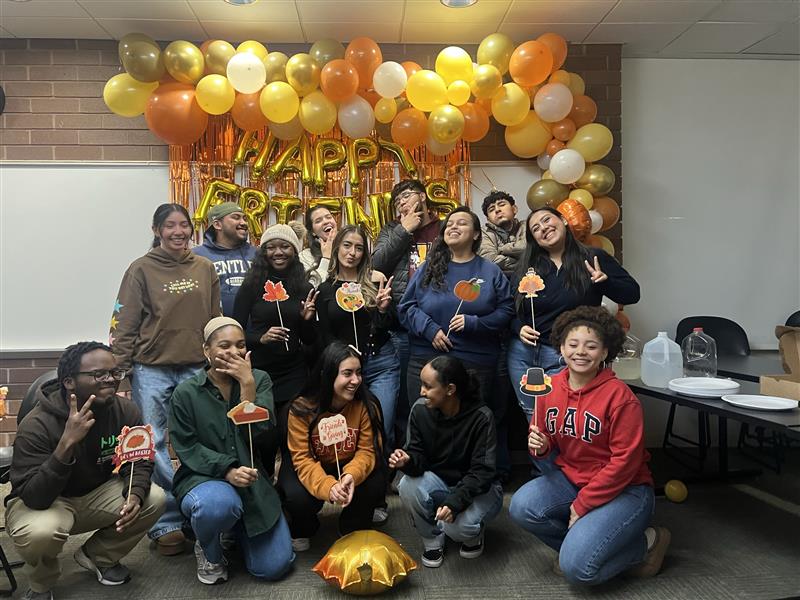 Loyola University Chicago Christo Rey academic scholars. Straight-on shot of 15 diverse students in two rows, smiling.