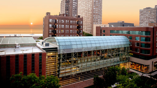 The sun rises over Lake Michigan and the Lake Shore Campus.