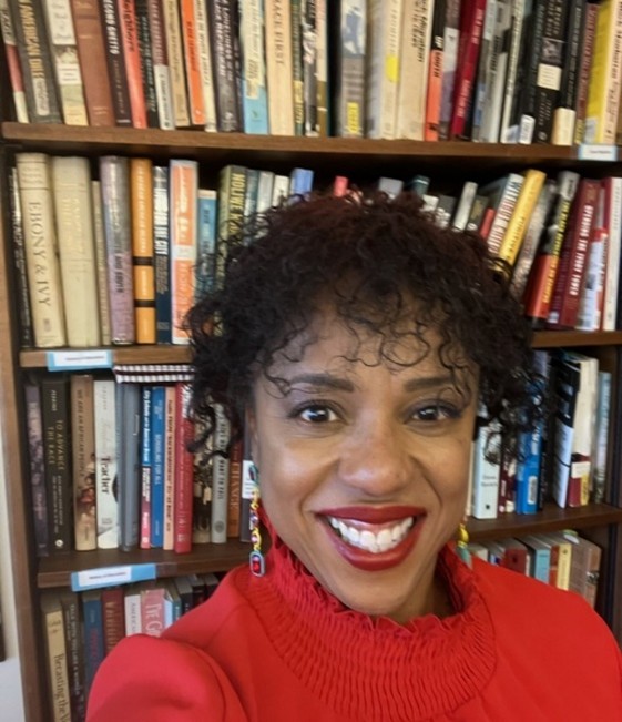Dr. Tikia Hamilton in her office in front of books.