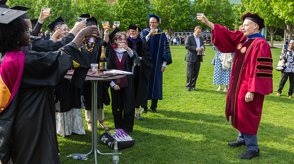 Professor Ted Karamanski toasts students at graduation