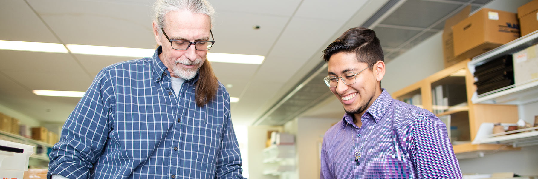 professor and student collaborate on project