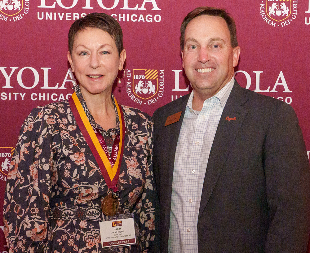 Janet Myers accepts the 2024 Spirit of Felice Award recipient from Mark C. Reed, President of Loyola University Chicago.