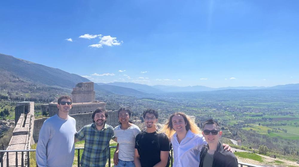 Students picture with Assisi landscape