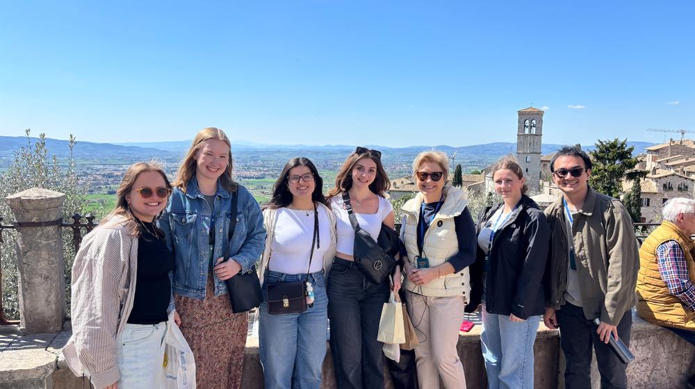 Students picture with Assisi landscape