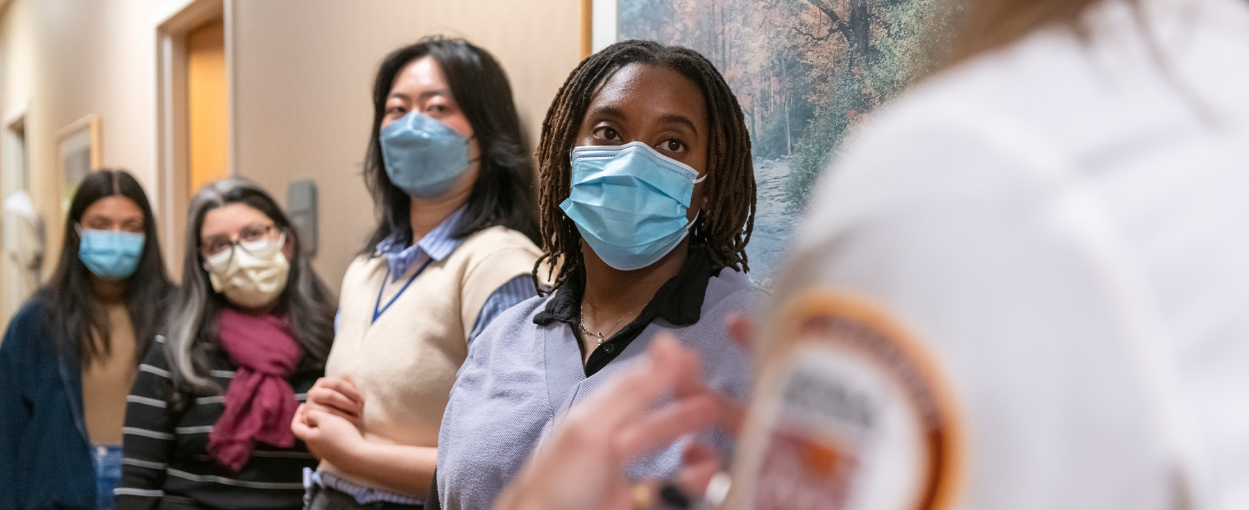 Health Justice Project students listen to a doctor