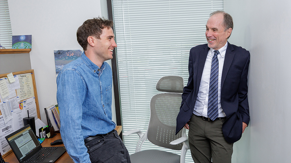 Andy Froelich with a co-worker in an office