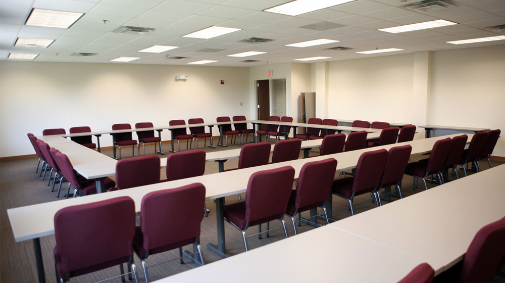 A empty conference room with maroon chairs