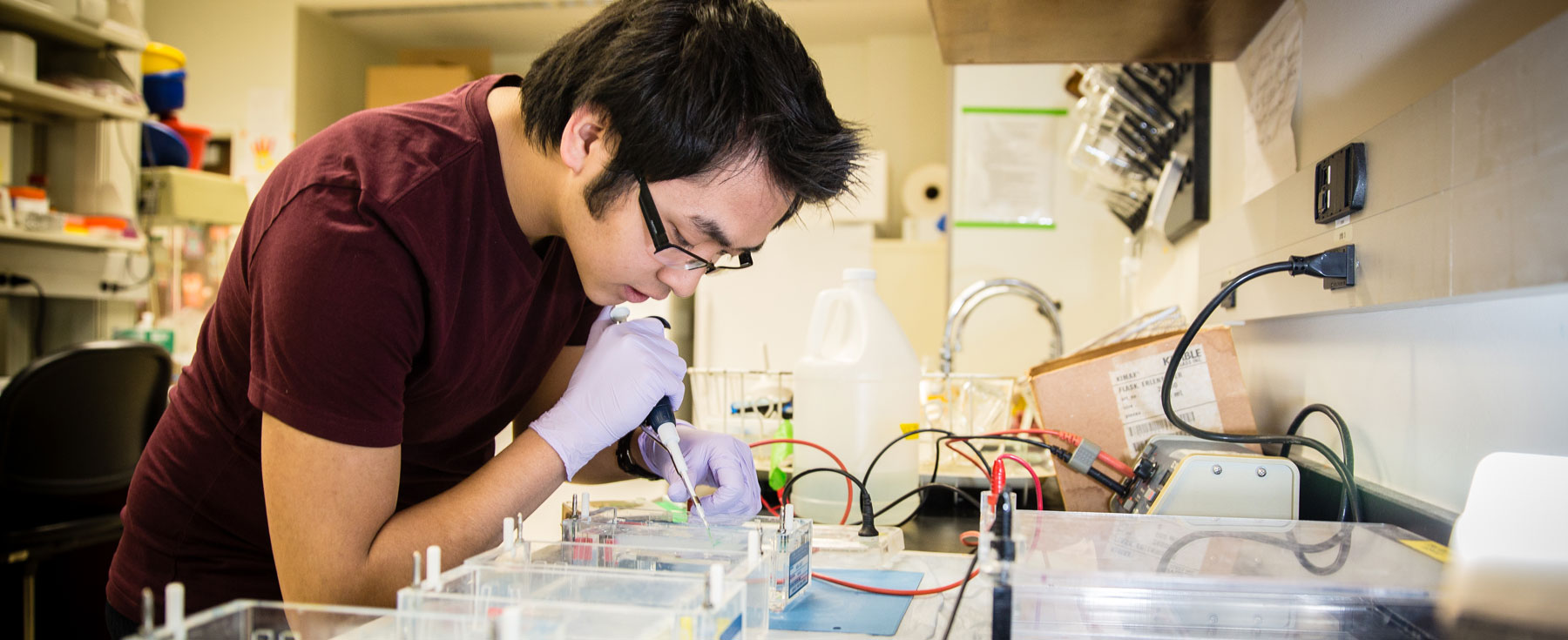Loyola University Chicago neuroscience student conducting lab research with pipe