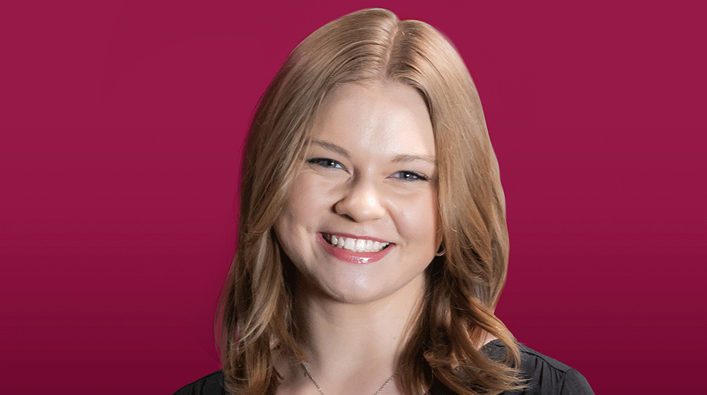 Headshot of Arianna Moen against maroon background