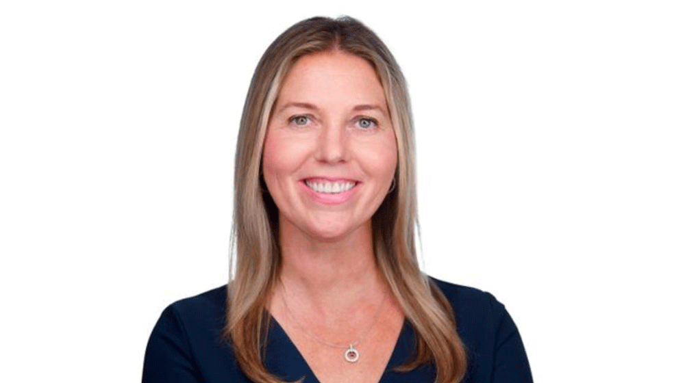 Melissa Murphey, wearing a dark shirt and necklace, is showing from the shoulders up, smiling