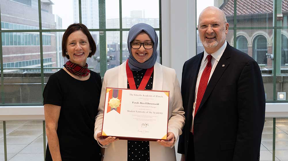 Farah Elhoumaidi standing with Dean Elaine Morrato and VP Phil Hale