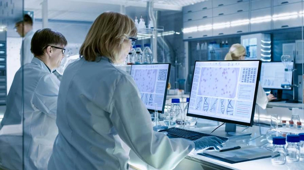 Doctors at computers in a medical lab