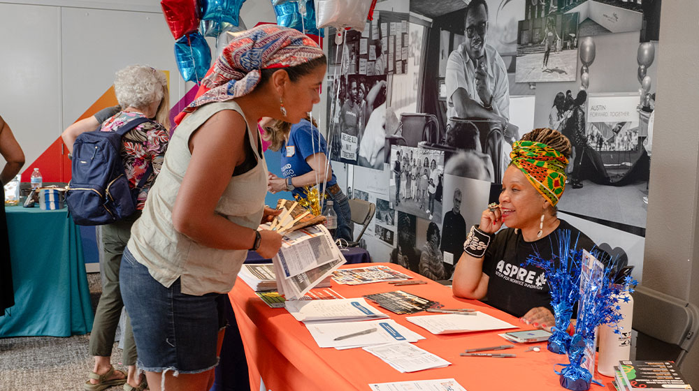 A community member learns more about the offerings of the Aspire Center for Work