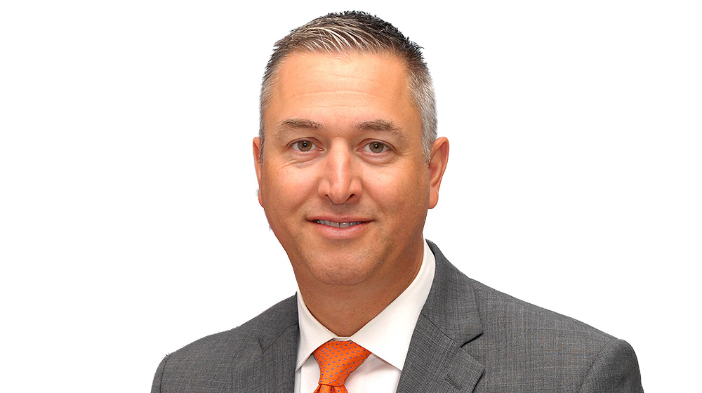 Headshot of Dan William. He is wearing a suit and tie.