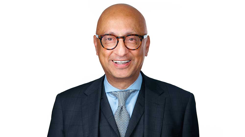 Dean Michal Behnam in front of a white background