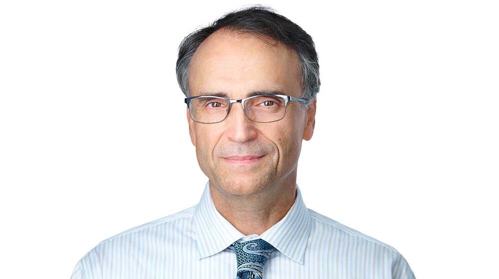Nenad Jukic on white background wearing a tie