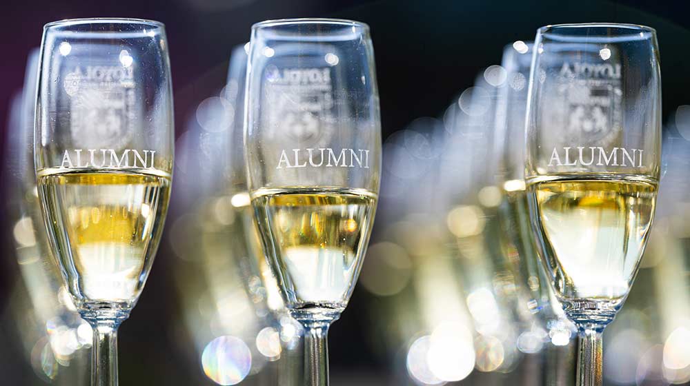 Image of champagne flutes with the Loyola shield and Image of champagne flutes with the Loyola shield and
