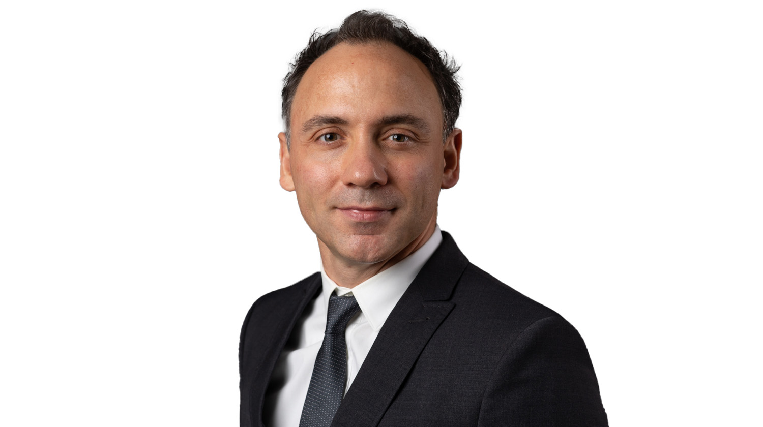 Headshot of Çerağ Pinçe in a black suit on a white background