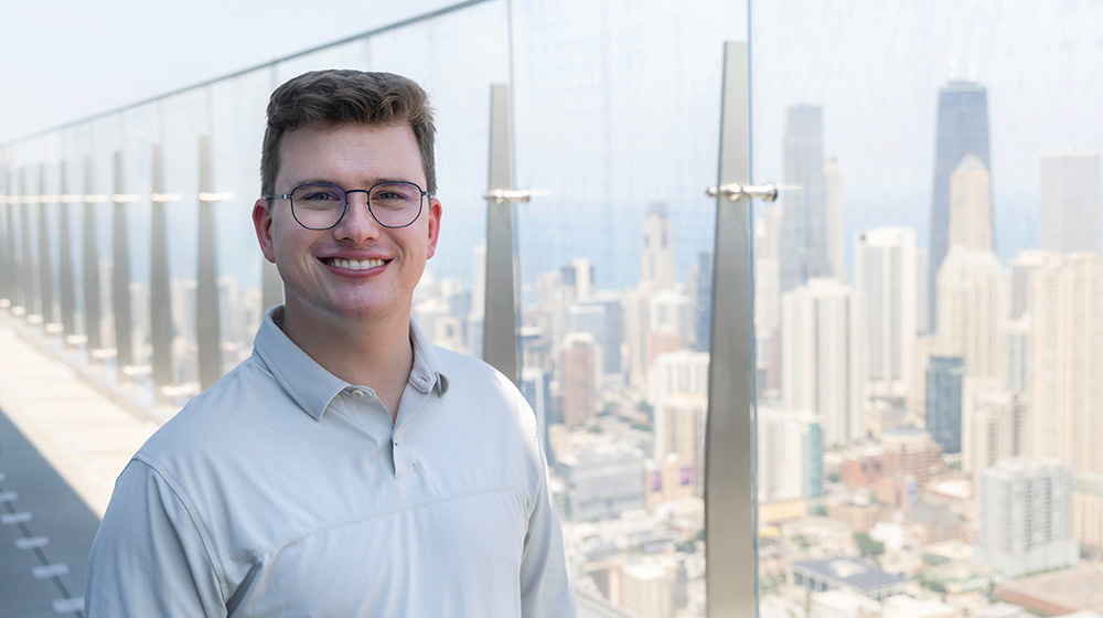 John Duffy stands on the roof of the Salesforce building overlooking the Chicago skyline