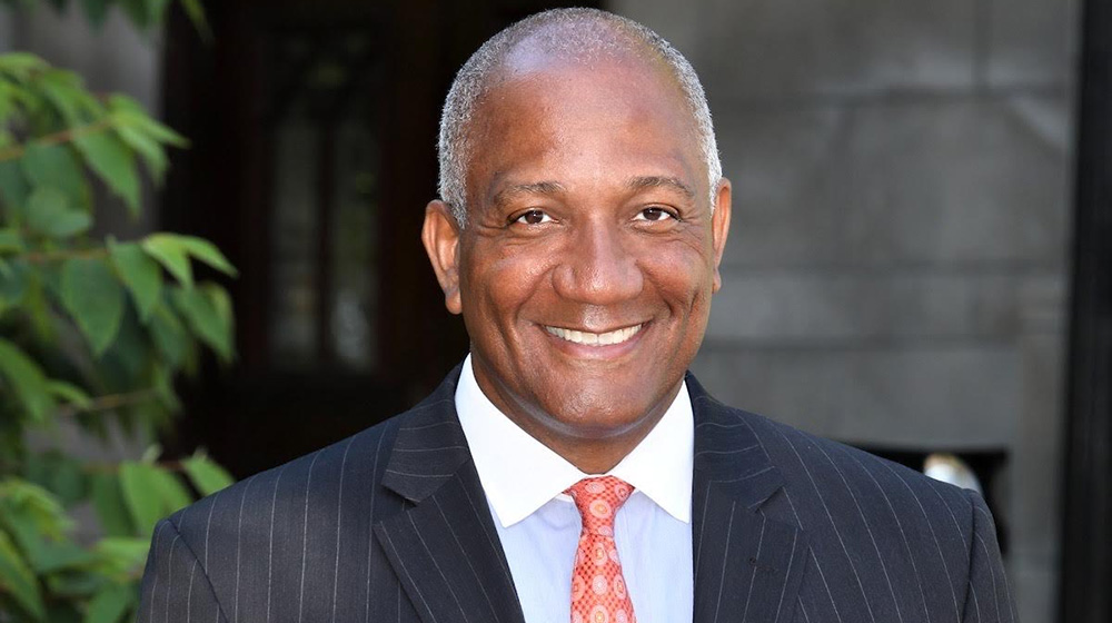 headshot of marquis miller in a suit and tie
