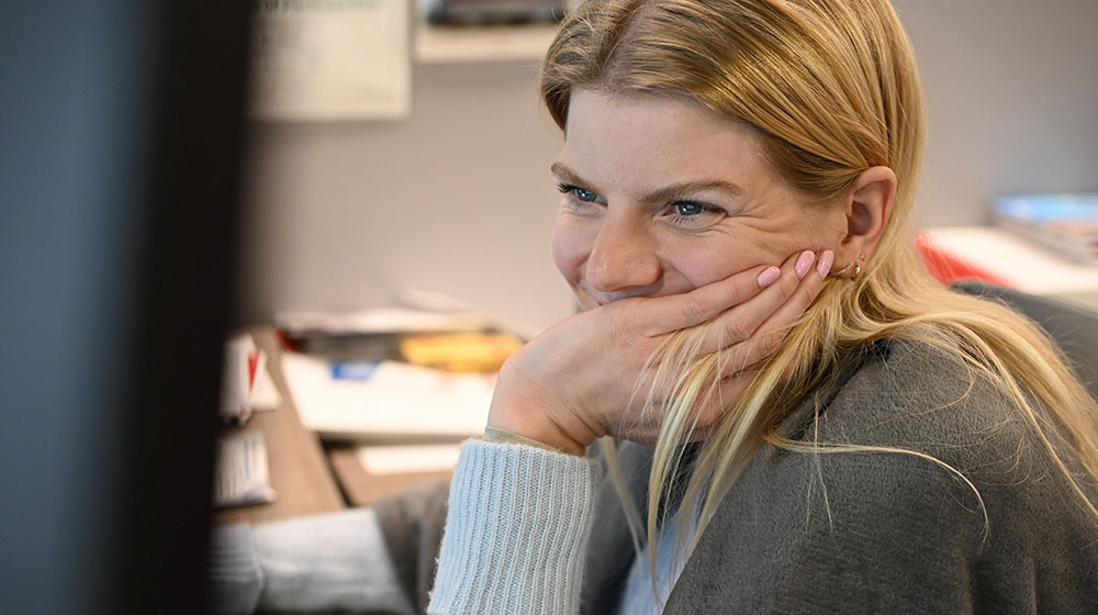 Mimi reimers sitting in an office smiling