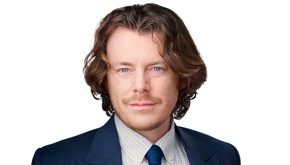Headshot of Peter Hulett in a blue suit