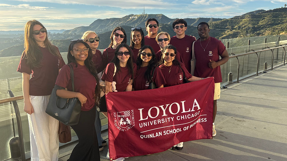 Quinlan students hold a Quinlan flag overlooking the Hollywood sign
