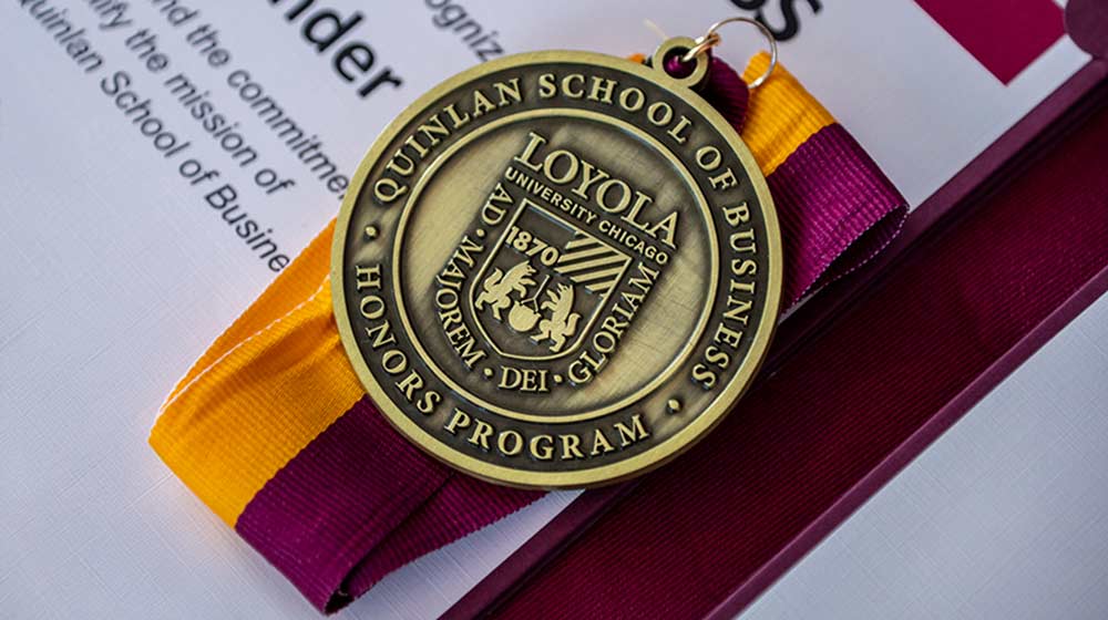 Business Honors Medal sitting on a certificate of recognition