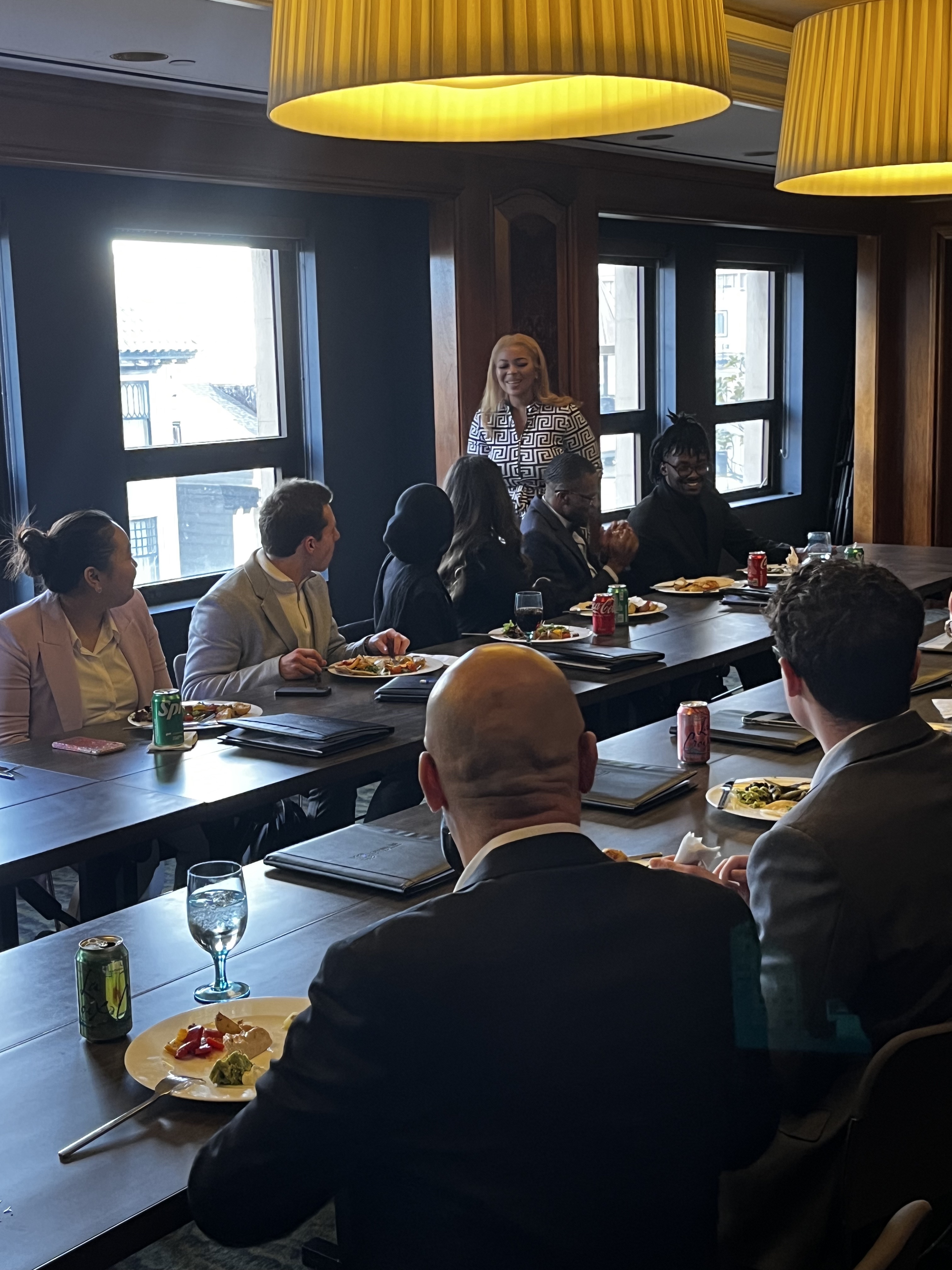 Alumna Genesis Emery greets our group of students at a meeting during the Quinlan Ramble to San Francisco.