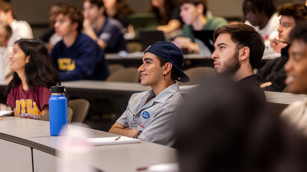 Several students in a classroom list intently to the instructor.