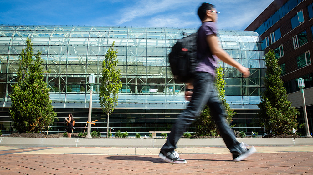 Student Walking In Front Of San Fran Dorms