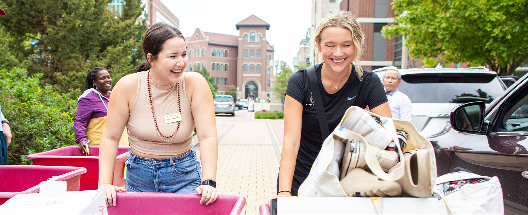 2023 Move In with two women pushing moving carts
